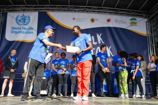 David Rudisha receives his accolade from WHO Director General Tedros Ghebreyesus. PHOTO| Courtesy