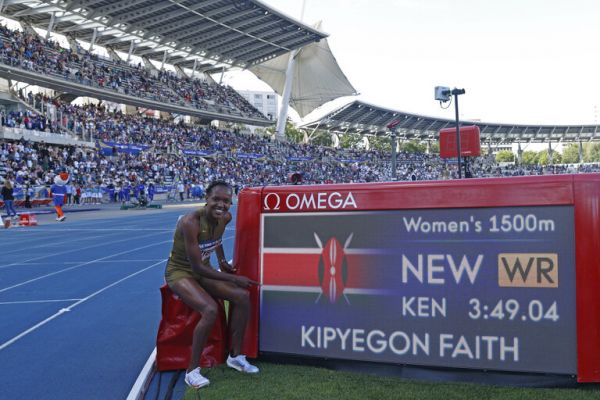 Faith Kipyegon poses besides the new world record time. PHOTO| AFP