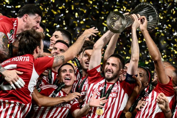 Olympiakos players celebrate lifting the 23/24 Europa Conference League trophy. PHOTO| AFP